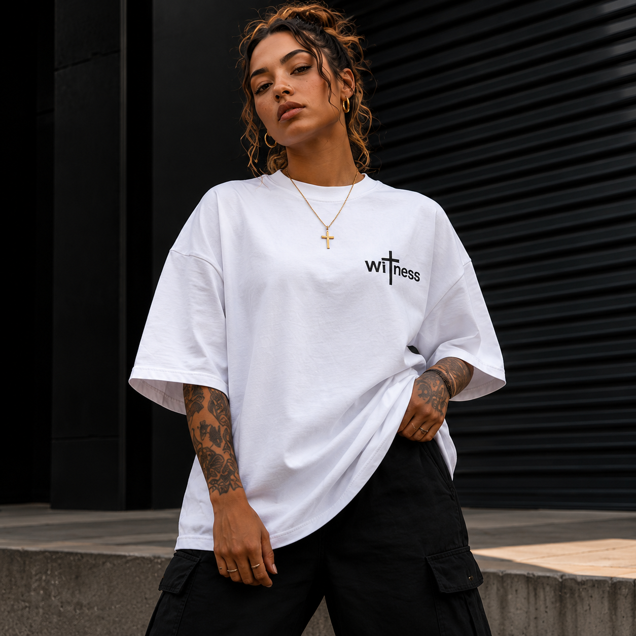 Modern oversized Christian streetwear t-shirt with minimalist Witness chest logo and premium urban fashion styling