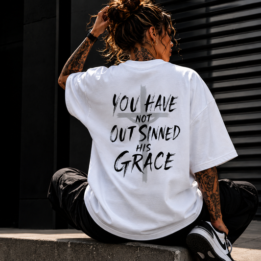 White oversized Christian streetwear t-shirt with “You Have Not Out Sinned His Grace” graphic and faded cross design for modern faith-based fashion